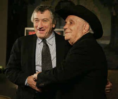 
Robert De Niro, left, and Jake LaMotta stand for photographers before watching a 25th anniversary showing of 