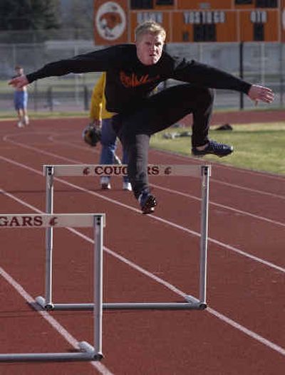 West Valley High's Chris Vennum runs through a hurdling drill in an after-school practice.
(Liz Kishimoto / The Spokesman-Review)