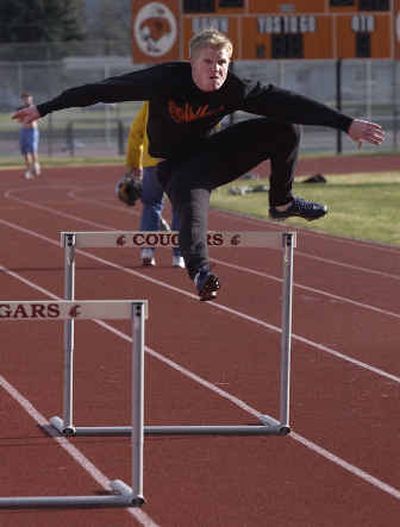 
West Valley High's Chris Vennum runs through a hurdling drill in an after-school practice. 
 (Liz Kishimoto / The Spokesman-Review)