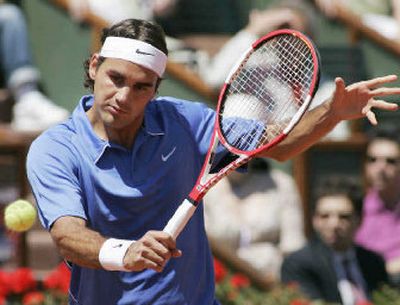 
Switzerland's Roger Federer returns the ball to Argentina's David Nalbandian in their semifinal match Friday.  
 (Associated Press / The Spokesman-Review)