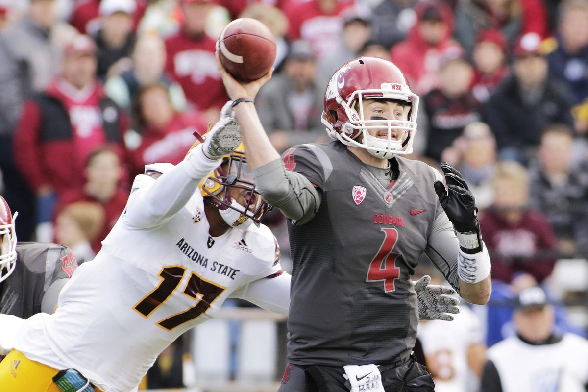 Washington State quarterback Luke Falk (4) passes as he is hit by Arizona State linebacker Ismael Murphy-Richardson (17) during the first half of an NCAA college football game, Saturday, Nov. 7, 2015, in Pullman, Wash. (Associated Press / AP)