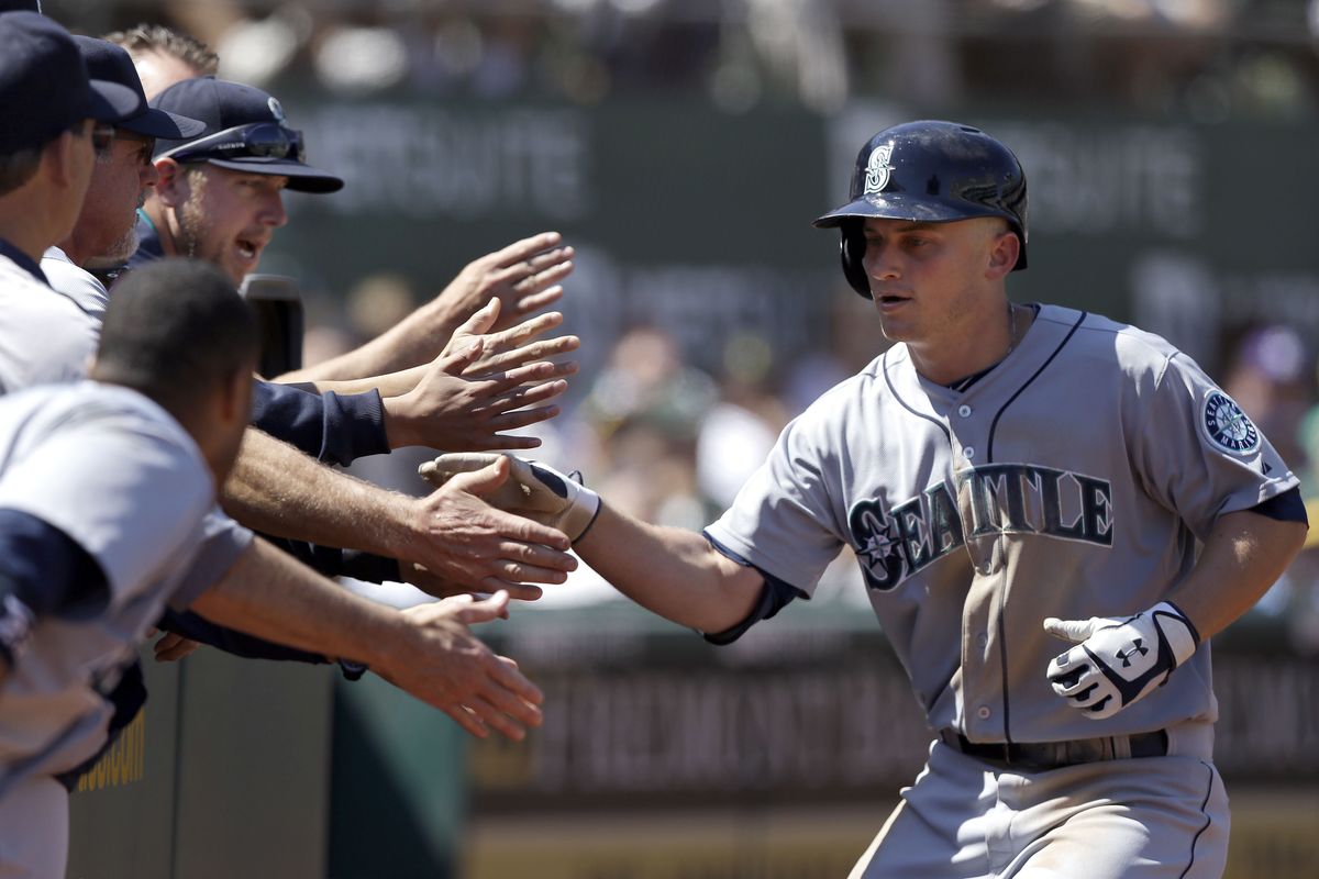 Mariners’ Kyle Seager returns to congratulations from the dugout after hitting his 22nd home run of the season, tying a career best. (Associated Press)