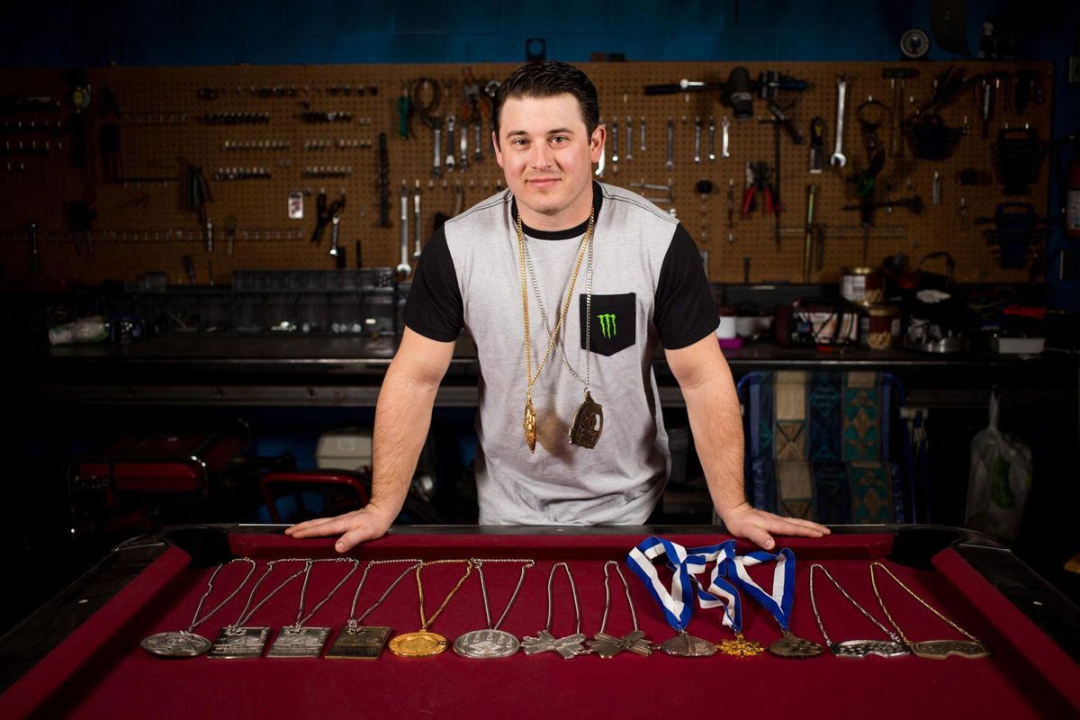 Snowmobile daredevil Joe Parsons poses for a portrait with his medals at his family garage in Yakima, Wash., Wednesday, Feb. 1, 2017. Parsons has more Winter X Games medals than anyone except Shaun White. He just won his 16th and 17th Winter X Games medals over the weekend in Aspen. (SOFIA JARAMILLO / SOFIA JARAMILLO/Yakima Herald-Republic)