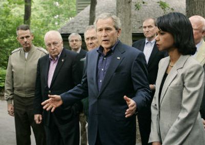 
President Bush speaks Monday in Camp David, Md., after meeting with, from left, Gen. Peter Pace, Vice President Dick Cheney, National Security Advisor Stephen Hadley, Secretary of Defense Donald Rumsfeld, Director of National Intelligence John Negroponte and Secretary of State Condoleezza Rice. 
 (Associated Press / The Spokesman-Review)