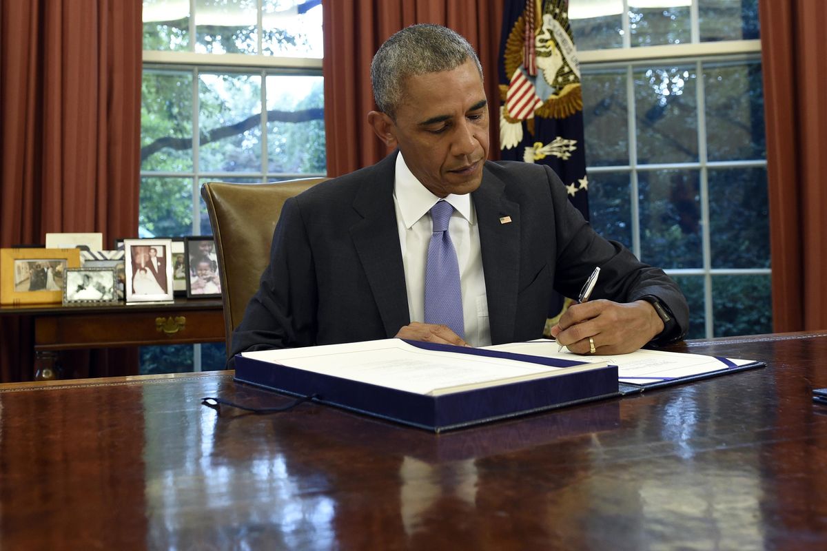 U.S. President Barack Obama signs the Puerto Rico Oversight, Management, and Economic Stability Act on Thursday, June 30, 2016, in the Oval Office of the White House in Washington. Puerto Rico faced a historic default Friday as the U.S. territory prepared to enter unchartered waters under the guidance of a newly enacted federal control board to oversee the island