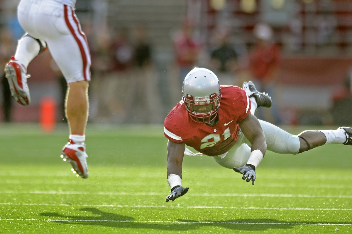 WSU defensive back #21 Chima Nwachukwu flies through the air but misses the tackle on Stanford running back #7 Toby Gerhart during second-half action of their PAC-10 conference game at Martin Stadium in Pullman on Saturday, Sept. 5, 2009.  (Christopher Anderson / The Spokesman-Review)