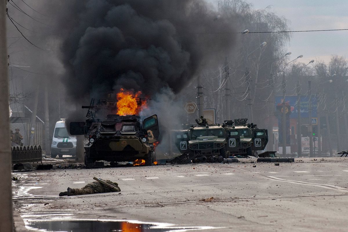 ADDS THAT THE PERSONNEL CARRIER IS RUSSIAN - A Russian armored personnel carrier burns amid damaged and abandoned light utility vehicles after fighting in Kharkiv, Ukraine, Sunday, Feb. 27, 2022. The city authorities said that Ukrainian forces engaged in fighting with Russian troops that entered the country