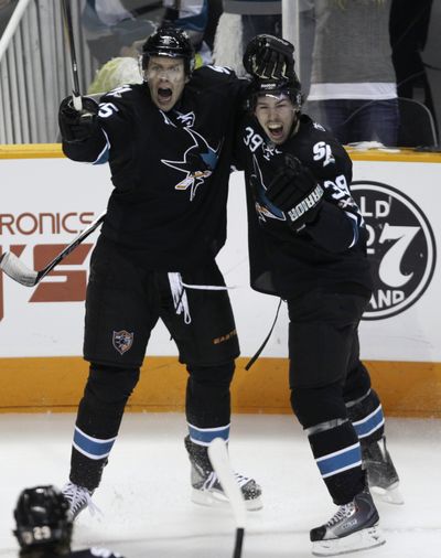 Sharks right wing Dany Heatley, left, is congratulated by center Logan Couture after Heatley scored in the first period. (Associated Press)