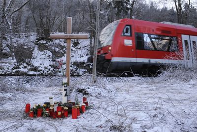 A cross, flowers and candles have been placed close to where German entrepreneur Adolf Merckle committed suicide on the rails near his house following financial ruin in the economic collapse. (FILE Associated Press / The Spokesman-Review)