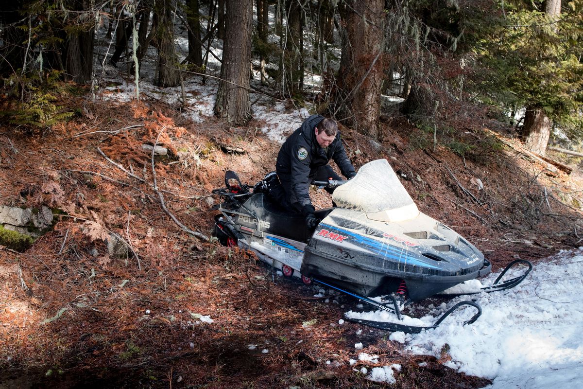 Ben Maletzke, the statewide wolf specialist for the Washington Department of Fish and Wildlife, backs turns his snowmobile around on a narrow Forest Service road on March 3, 2020. Unusually warm weather and a low snowpack make the annual wolf survey more difficult, Maletzke said. ELI FRANCOVICH/THE SPOKESMAN-REVIEW. (Eli Francovich / The Spokesman-Review)