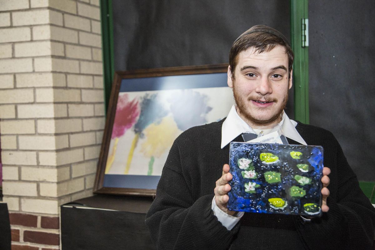 Avi of Philadelphia displays his artwork during the Philly Friendship Circle’s annual art show in 2019. (Courtesy of the Philly Friendship Circle)