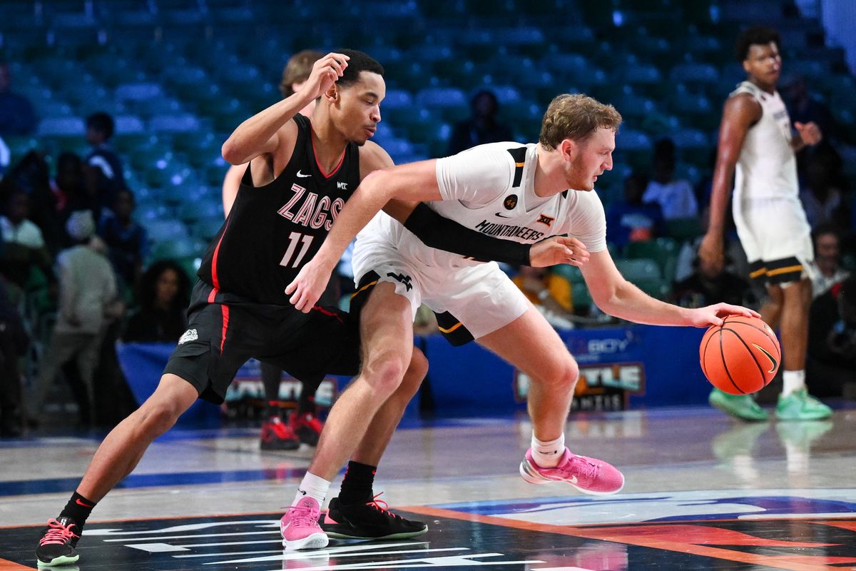 Gonzaga Bulldogs guard Nolan Hickman (11) guards West Virginia Mountaineers guard Tucker DeVries (12) during the second half of a college basketball game on Wednesday, Nov. 27, 2024, at Paradise Island, Bahamas. The West Virginia Mountaineers won the game 86-78 in overtime.  (Tyler Tjomsland/The Spokesman-Review)