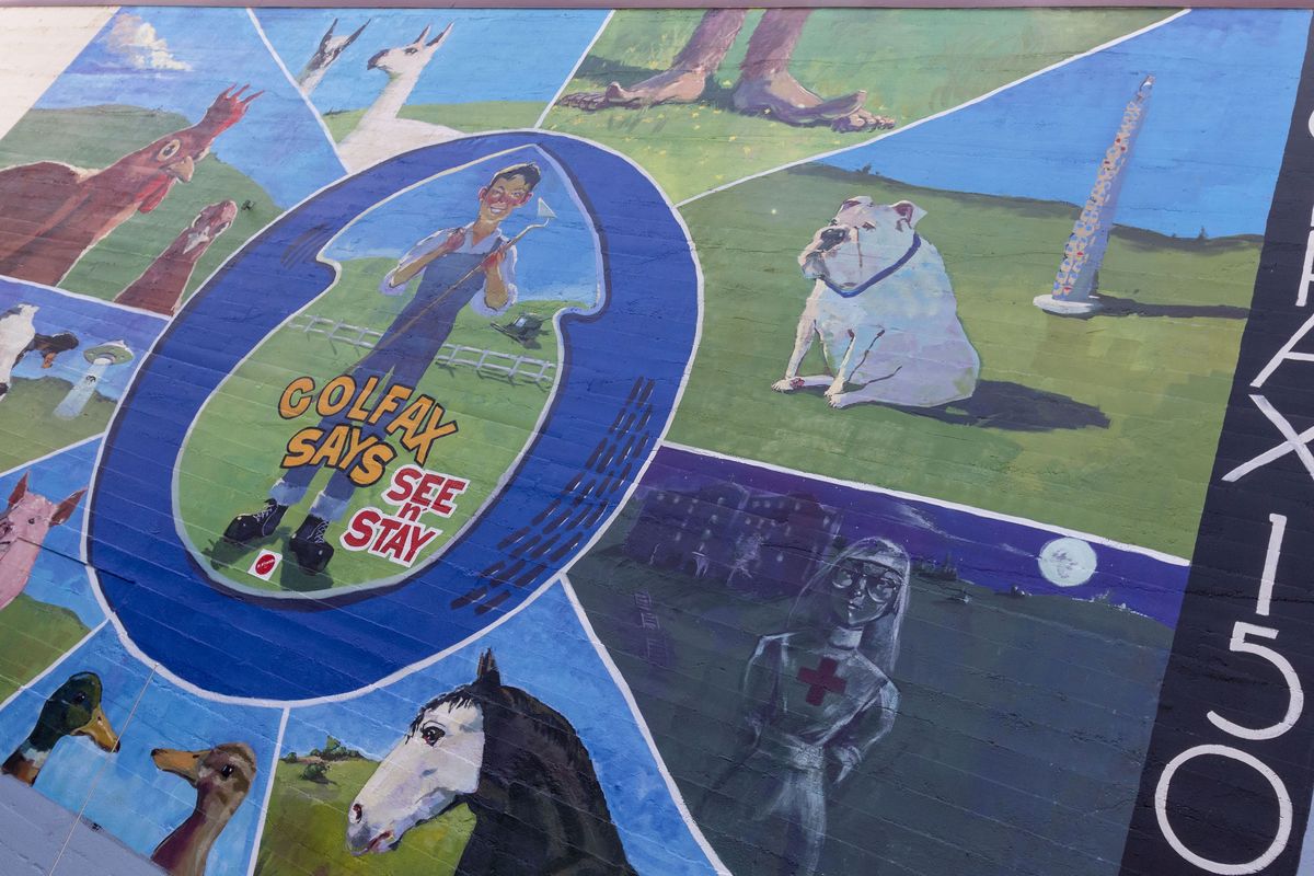 Artist Henry Stinson painted this mural on the end of the Whitman County Public Services Building in Colfax to commemorate the town's 150th anniversary. There will be a town celebration on July 23 and 24.  (Geoff Crimmins/For The Spokesman-Review)