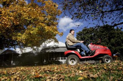 David Snyder took advantage of the nice fall weather (2005) to mulch leaves in his yard in Burlington, Iowa.
(AP / The Spokesman-Review)
