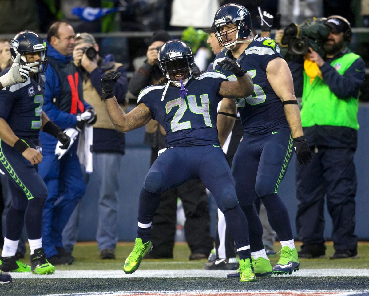 Seahawks running back Marshawn Lynch celebrates after his touchdown run in the fourth quarter – his second of game – helps fend off Saints in Seattle.