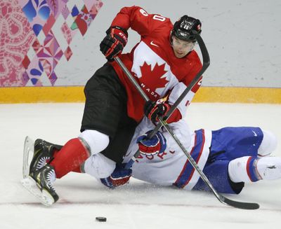 FILE - In this Feb. 13, 2014 file photo, Canada forward John Tavares loses his footing against Norway defenseman Ole-Kristian Tollefsen in the third period of a men's ice hockey game at the 2014 Winter Olympics in Sochi, Russia. Tavares says he and other players in the league want the NHL to let them participate in a sixth straight Olympics. The union representative, though, knows the stay-or-go topic has become a bargaining chip for the league and NHL Players Association. (Mark Humphrey / Associated Press)