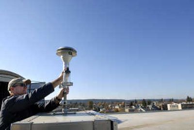 
Air quality technician Mark Rowe reattaches an air intake apparatus to the top of an air pollution monitor on top of the Spokane Regional Health District on Nov. 1. 
 (Holly Pickett / The Spokesman-Review)
