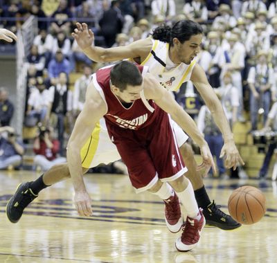 California’s Jorge Gutierrez attempts to steal the ball from WSU’s Taylor Rochestie during first-half play.  (Associated Press / The Spokesman-Review)