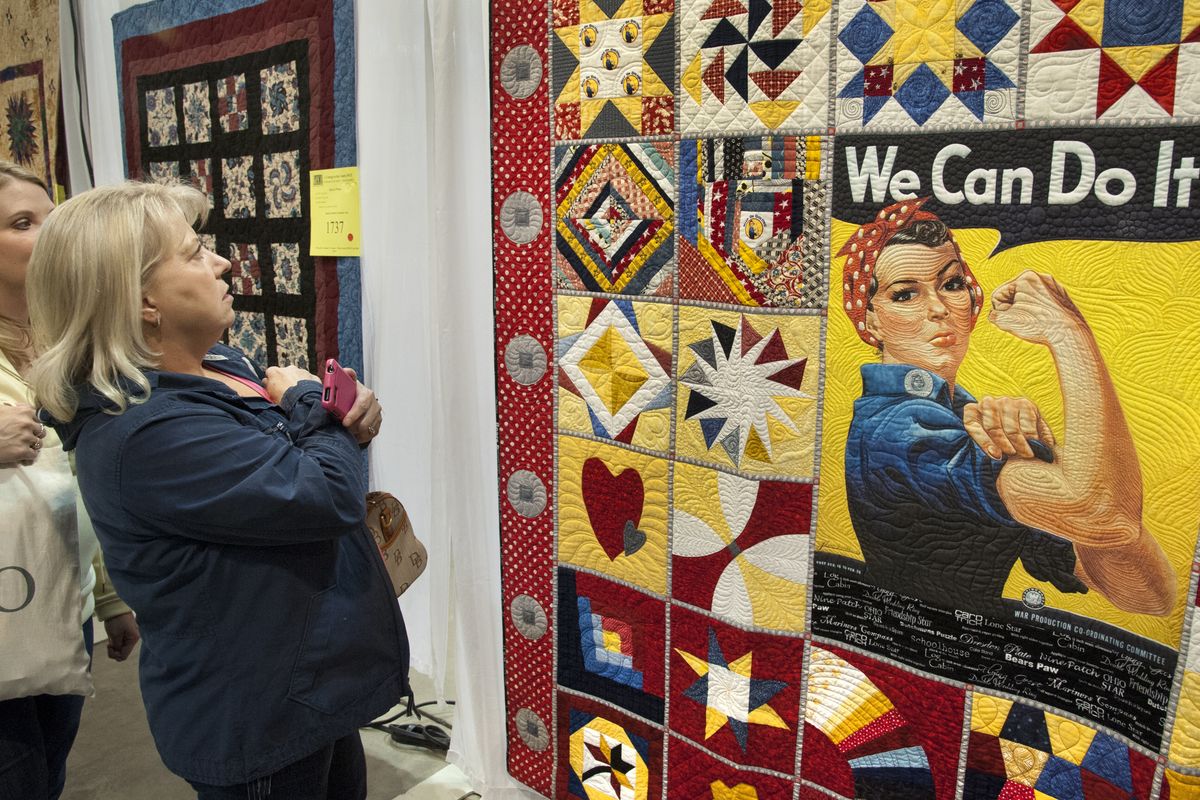 Karen Ray and her daughter, Kelly Anderson, left, get a close view of Marlene Oddie’s “Rosie” at the Washington State Quilters-Spokane Chapter 35th Annual Quilt Show on Saturday at the Spokane County Fair & Expo Center. After taking in most of the quilt displays, Ray said, “This is it. Our super favorite.” (PHOTOS BY DAN PELLE)