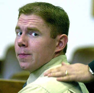 
Fred Russell turns to the court audience as his father puts a hand on his shoulder during a court appearance in 2001.  
 (File/ / The Spokesman-Review)