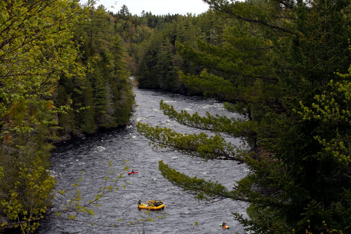 FILE - Whitewater rafters paddle on the Kennebec River in The Forks, Maine, on May 28, 2019. On the Kennebec River, conservation groups and state environmental agencies are pushing for the removal of four hydropower dams that block endangered Atlantic salmon from reaching habitat. The dams generate about 5% of the state’s renewable energy.  (Robert F. Bukaty)