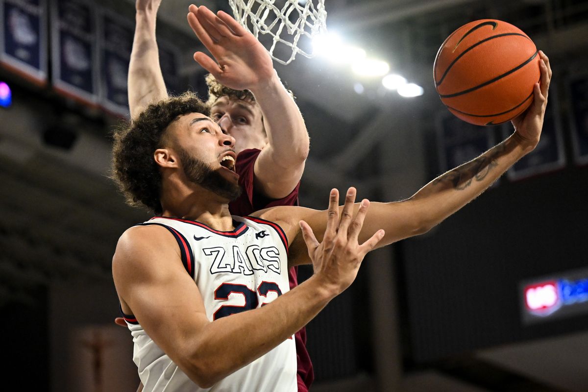 Gonzaga Bulldogs forward Anton Watson (22) reverses the ball under the hoop and scores against the Santa Clara Broncos during the second half of a college basketball game on Saturday, Feb. 24, 2024, at McCarthey Athletic Center in Spokane, Wash. Gonzaga won the game 94-81.  (Tyler Tjomsland/The Spokesman-Review)
