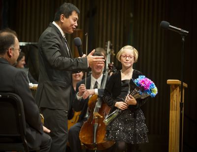 Take a bow: Spokane Symphony Resident Conductor Morihiko Nakahara congratulates Mullan Road Elementary School fourth-grader Peggy Sue Bristol, 9, after she guest-conducted the orchestra. All Spokane Public Schools fourth-graders attended one of two Spokane Symphony concerts held Wednesday at the Martin Woldson Theater at the Fox. A grant from the Washington Arts Commission covered the symphony performance and accompanying curriculum at no cost to the school district. (Colin Mulvany)