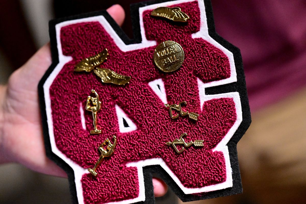 Debbie Robertson (Rosengart) shows off her letter with pins during North Central’s class of 1978’s 45th year reunion on Saturday, Aug. 5, 2023, at VFW 51 in Spokane. Class member Lori Barnett organized getting pins and letters for women who lettered as NC athletes.  (Tyler Tjomsland/The Spokesman-Review)