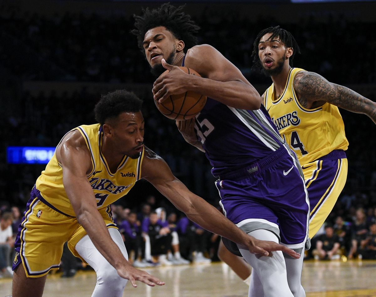 Sacramento Kings forward Marvin Bagley III drives past Los Angeles Lakers forward Johnathan Williams during the second half of a preseason  game in Los Angeles on Oct. 4. (Kelvin Kuo / AP)