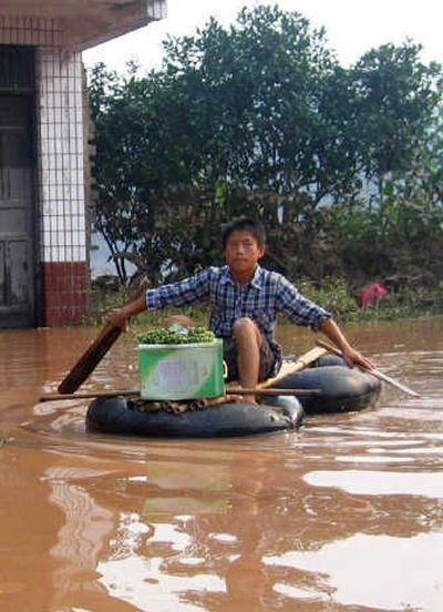 
A boy  rafts in floodwaters in the Qinglong township of Quxian County in southwest China  on Sunday. Associated Press
 (Associated Press / The Spokesman-Review)