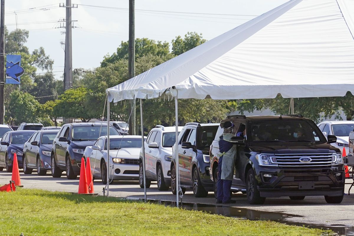 Cars line up at Miami Dade College North campus' COVID-19 testing site, Thursday, July 29, 2021, in Miami. Hospital admissions of coronavirus patients continue to soar in Florida with at least two areas in the state surpassing previous peaks reached during last summer's surge.  (Marta Lavandier)