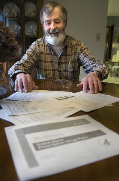 
Kit Sherfey wades through piles of information on the Medicare drug plan Friday  at his Spokane home. 
 (Christopher Anderson / The Spokesman-Review)