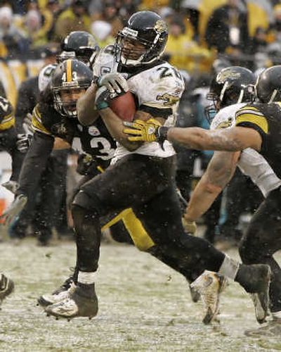
Fred Taylor runs for the decisive touchdown in Jacksonville's win in cold, snowy Pittsburgh. Associated Press
 (Associated Press / The Spokesman-Review)