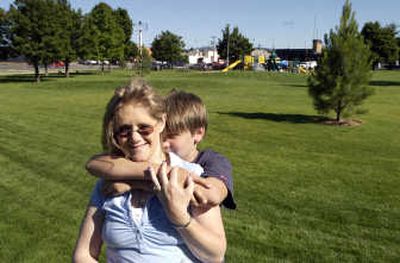 
Theresa Woolery and her son Jason enjoy the early evening in Balfour Park, behind the fire station on Sprague Avenue across from U-City. Woolery is the driving force behind improvements at the park including new landscaping for walking paths, a new fence, sod and playground equipment that she selected.
 (J. BART RAYNIAK / The Spokesman-Review)