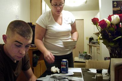 
Ryan and Jessica Elkins finish up dinner in their Spokane Valley apartment Tuesday. The couple is expecting a baby next spring.
 (Holly Pickett / The Spokesman-Review)