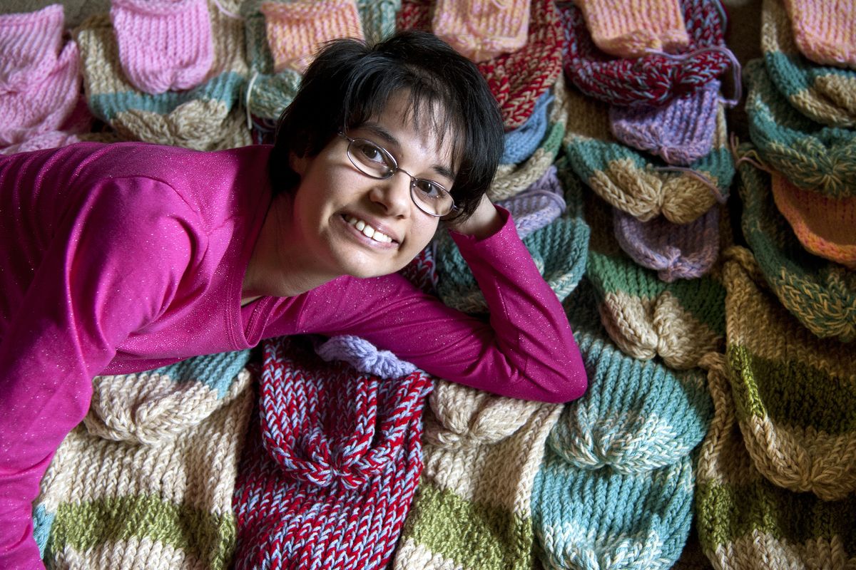 Thanks to “incredible patience and perseverance,” Sarah Bade, who is developmentally delayed and has cerebral palsy, has mastered the craft of loom knitting. She has knitted and donated hundreds of hats for babies and adults. (Dan Pelle)