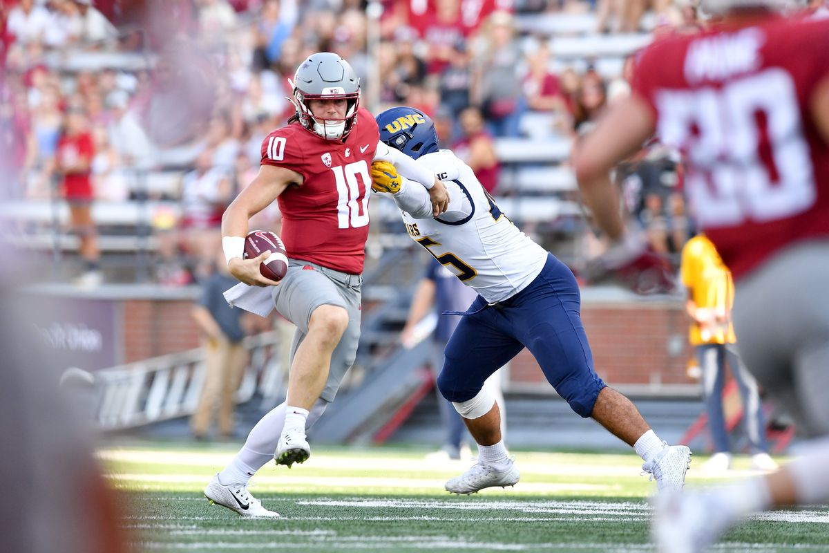 Washington State Cougars quarterback John Mateer (10) slips away from Northern Colorado Bears linebacker Tama Tuitele (45) during the second half of a college football game on Saturday, Sept. 16, 2023, in Pullman, Wash. WSU won the game 64-21.  (Tyler Tjomsland/The Spokesman-Review)