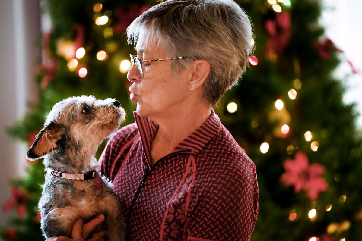 Theresa Fall talks to her dog Liberty at their home on Dec. 5 in Spokane Valley. Liberty was abandoned and living in an almond orchard for a month in Winton, Calif. Wings of Rescue brought the dog to SpokAnimal and now she lives with the Fall family.  (Kathy Plonka/The Spokesman-Review)