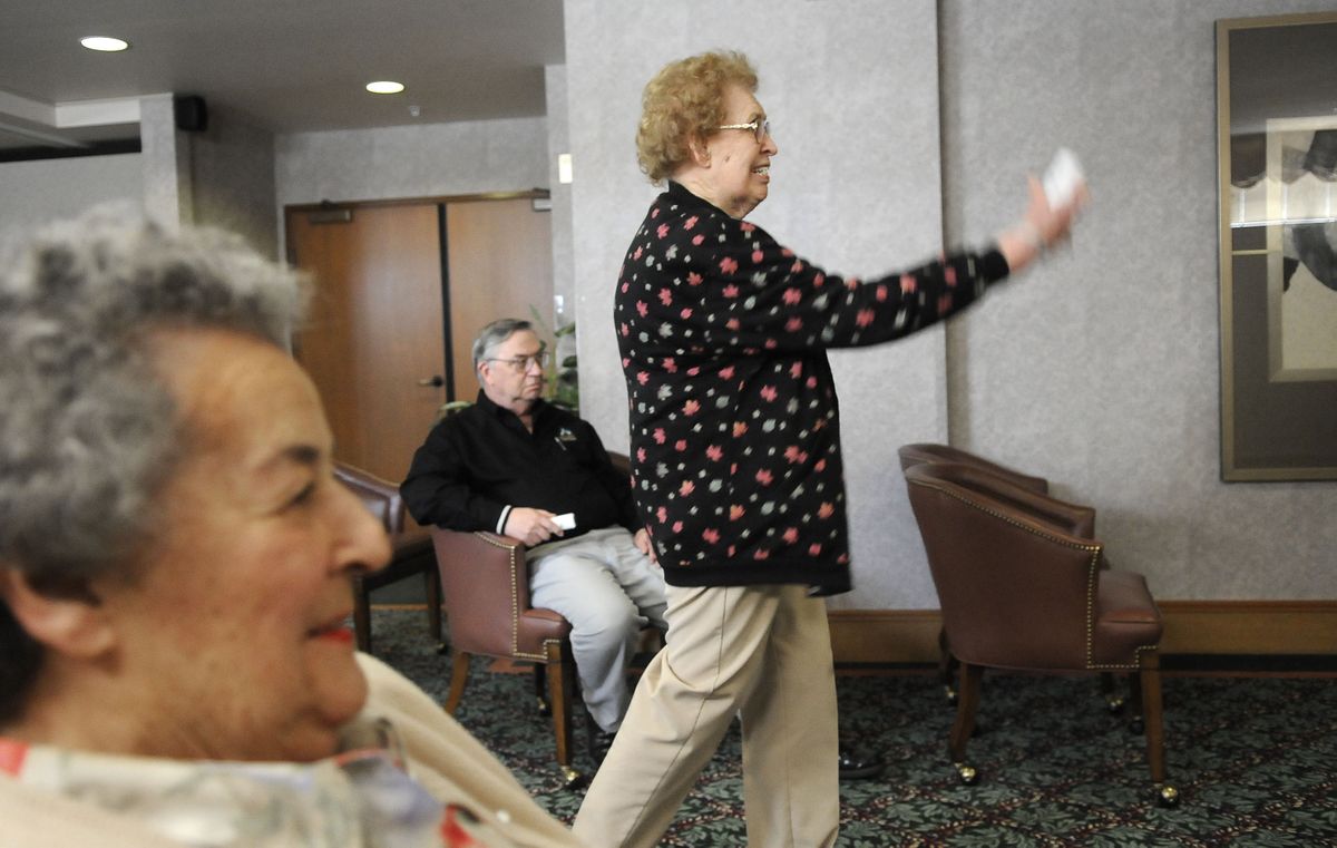 June Nilson launches a bowling ball while playing a practice game on the Nintendo Wii  on May 11 at the Fairwinds Northpointe Retirement Community. Eleanor Nigro, left, and Chuck Pursell wait their turn.  (Photos by Dan Pelle / The Spokesman-Review)