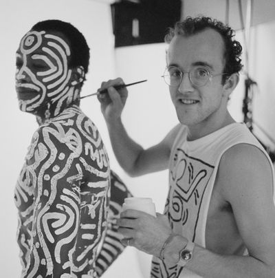 American artist Keith Haring (1958-90) body-paints American choreographer, director, author and dancer Bill T Jones before a 1983 photo shoot in London. (Tribune News Service)