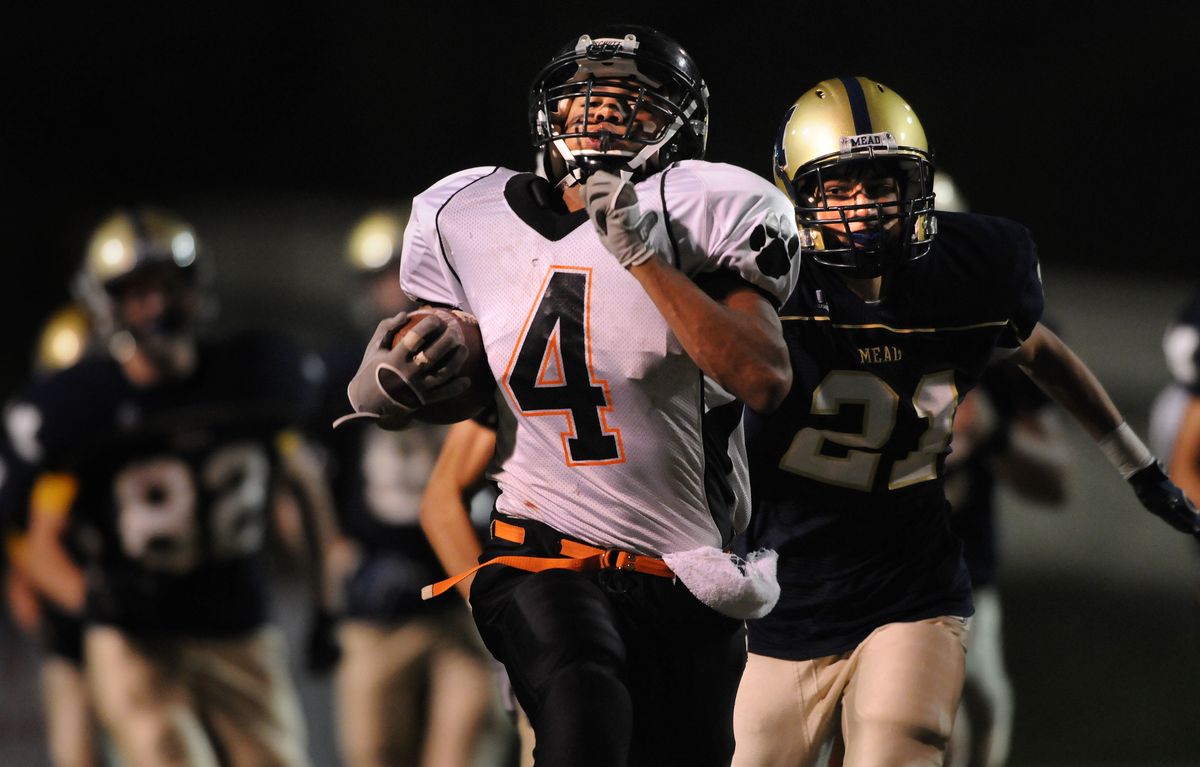 Lewis and Clark’s Levi Taylor leaves Casey Monahan and the rest of Mead in the dust in the third quarter of their game Friday.  (Rajah Bose / The Spokesman-Review)
