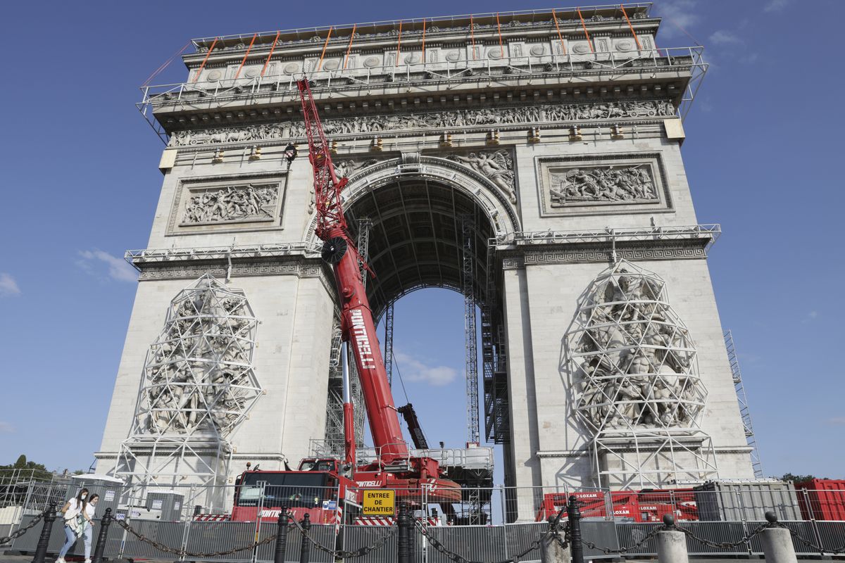 Cranes operate at the Arc de Triomphe in Paris, Tuesday, Aug.24, 2021. The "L