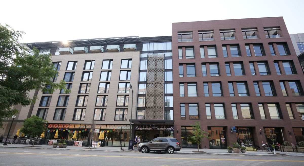 A vehicle stands in the loading zone outside the Maven Hotel Sunday, July 11, 2021, in lower downtown Denver. Authorities said four people have been arrested on drug and weapons charges after a "report of a suspicious occurrence” at the downtown Denver hotel, which is located near Coors Field, the site of Major League Baseball