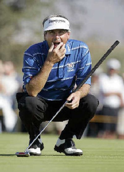 
Fred Couples studies the lie of his birdie putt. He later sank it for three skins and $475,000. 
 (Associated Press / The Spokesman-Review)