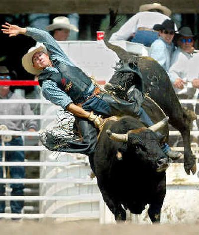 
Victor Dubray from La Grande, Ore., tries to stay on the bull during competition at the Cheyenne Frontier Days rodeo last year. Cheyenne Frontier Days, begun in 1897, is now a nine-day celebration attracting 200,000 people a year.
 (Associated Press / The Spokesman-Review)