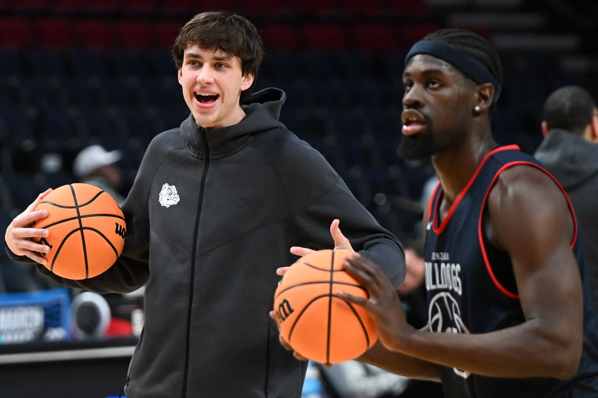 Gonzaga forward Braden Huff, left, laughs as teammate Graham Ike works on 3-pointers during a practice on Wednesday before their NCAA Tournament first-round game against Kennesaw State Owls on Thursday at Moda Center in Portland, Ore.  (Tyler Tjomsland / The Spokesman-Review)