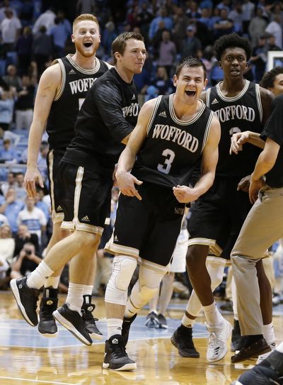 Wofford players, including Fletcher Magee (3), Matthew Pegram, left rear, and Michael Manning Jr., right rear, celebrate the team’s 79-75 win over North Carolina in an NCAA college basketball game in Chapel Hill, N.C., Wednesday, Dec. 20, 2017. (Ellen Ozier / Associated Press)