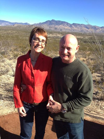 U.S. Rep. Gabrielle Giffords and husband, Mark Kelly, pose at the Davidson Canyon Gabe Zimmerman Memorial trailhead in Arizona on Saturday. (Associated Press)