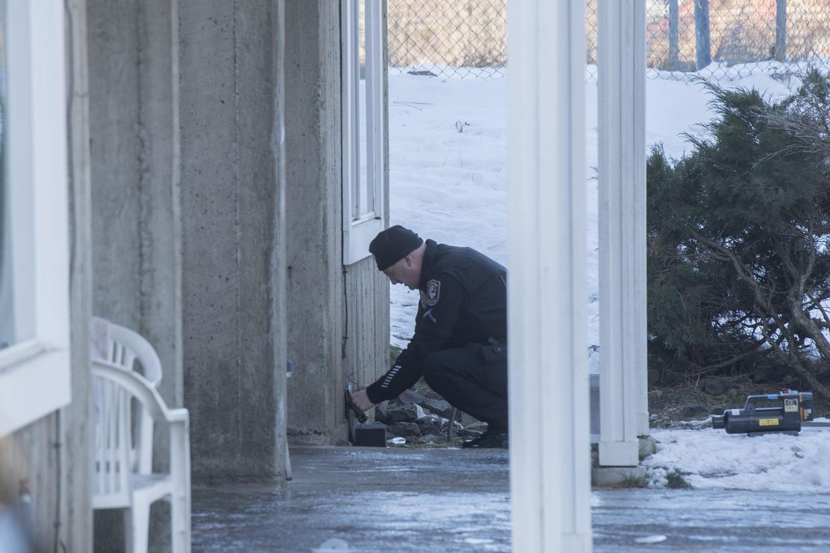 A police investigator works outside the apartment where a woman died in a fire early Friday, Feb. 23, 2018 at the Liberty Park Terrace Apartments in the Perry District. (Jesse Tinsley / The Spokesman-Review)