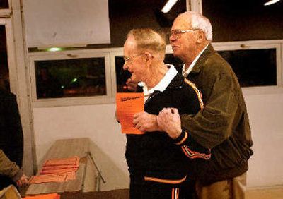 
Former West Valley High School coach Jud Heathcote, right, greets retired WV teacher Ken Moore before the start of the Alumni Game on Wednesday.  Moore taught in a classroom adjacent to Heathcote's in the 1950s. They both taught math. 
 (Brian Plonka / The Spokesman-Review)